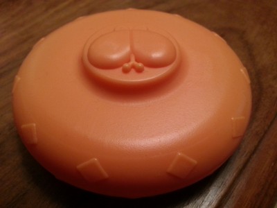 Child's stacking toy with embossing that looks like a bottom and a penis.