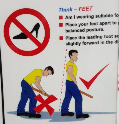 A safety sign saying to place your feet apart and showing a man with what appears to be an erection