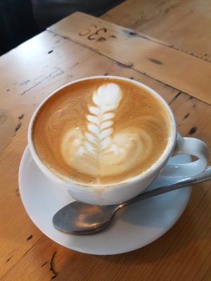 A photo of a coffee with a phallic shape to the froth